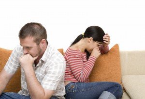 angry couple sitting on sofa